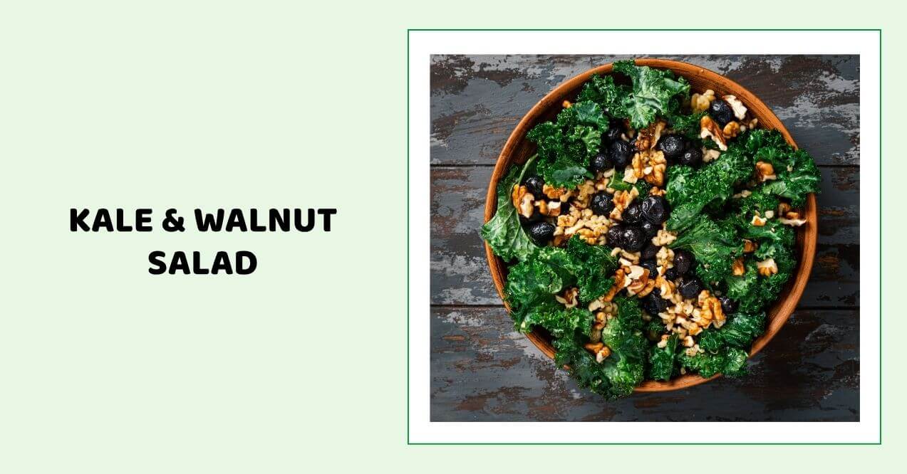 Kale and walnut salad with dark berries in a wooden bowl.