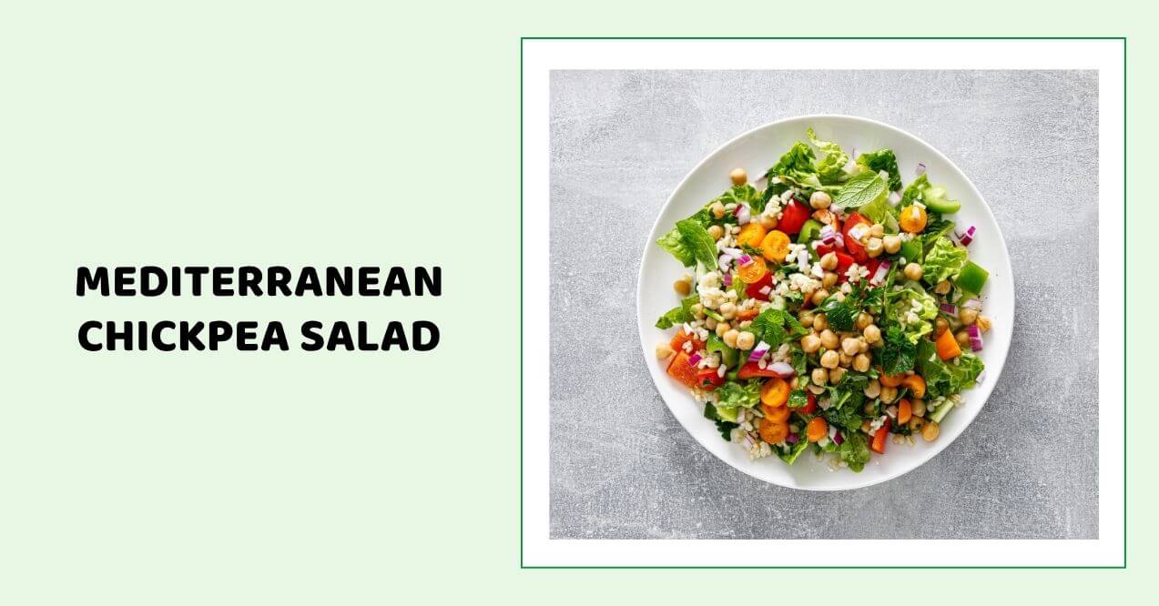 Fresh Mediterranean chickpea salad with vegetables on a white plate.
