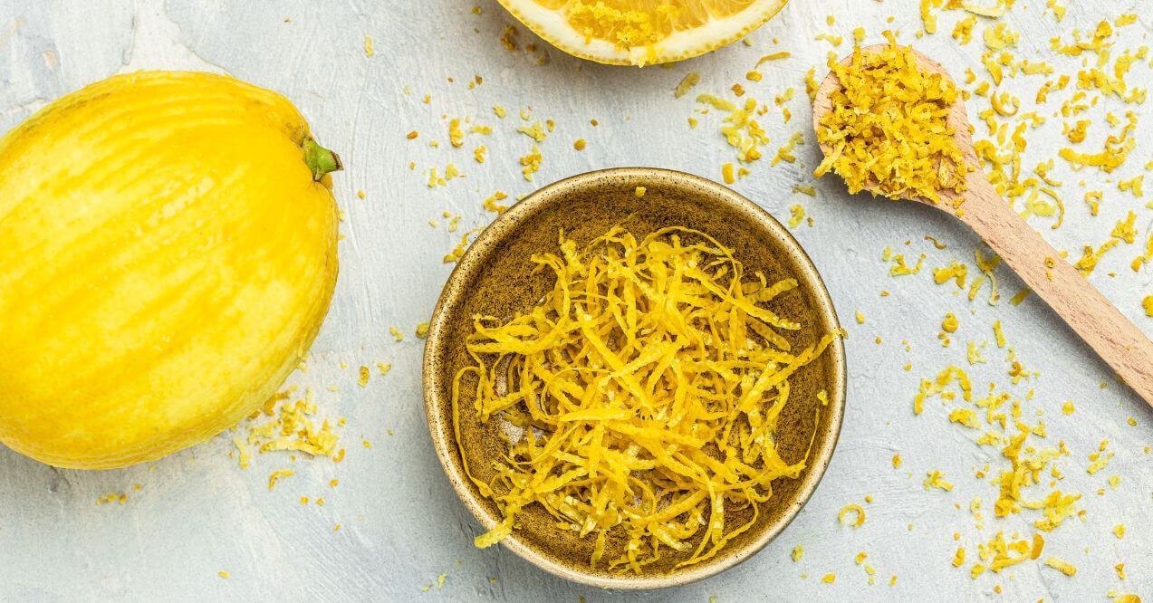 Grated lemon peel in a bowl resembling lemon peels to help with lymphatic drainage.
