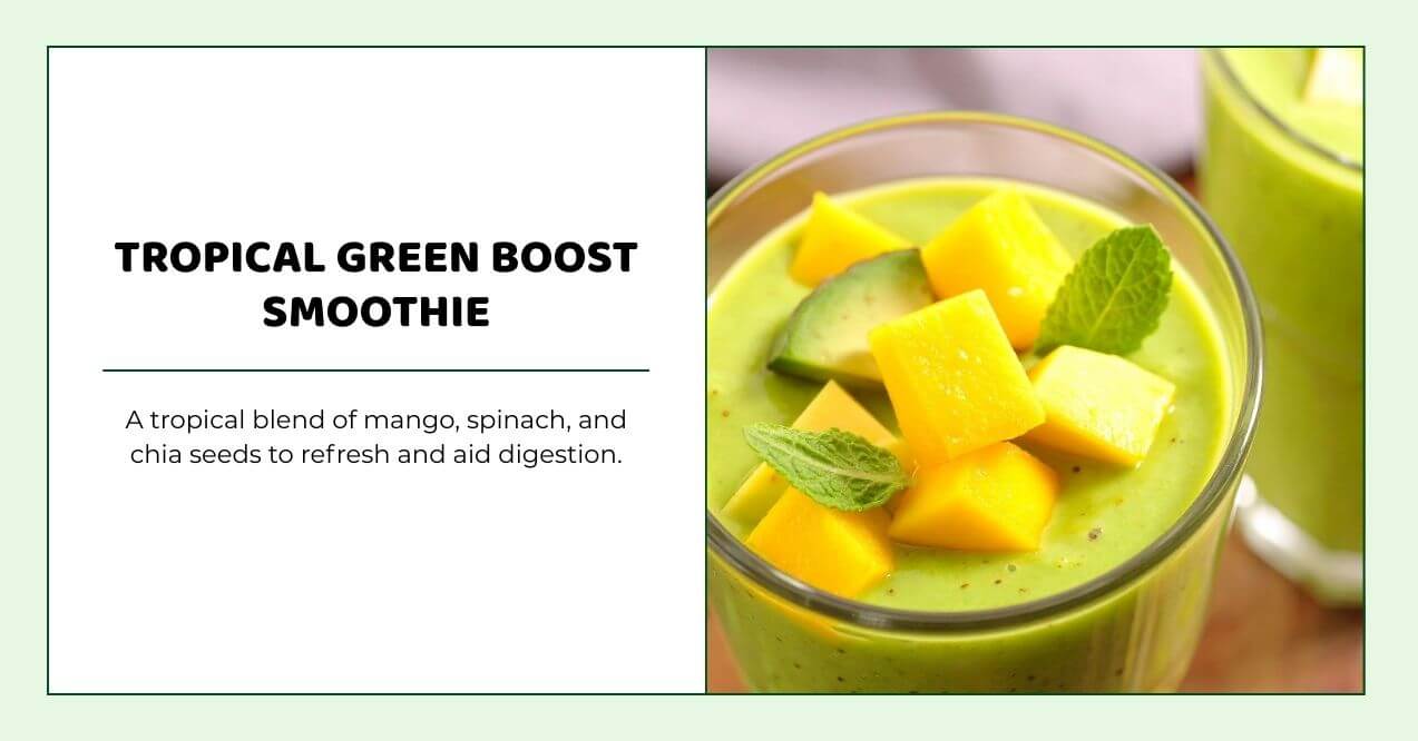 Green mango and spinach smoothie in glass topped with fresh mango cubes